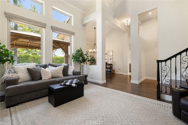 2666 Peacock Pl, La Verne, CA 91750 - living room with a towering ceiling, wood finished floors, stairs, a chandelier, and crown molding