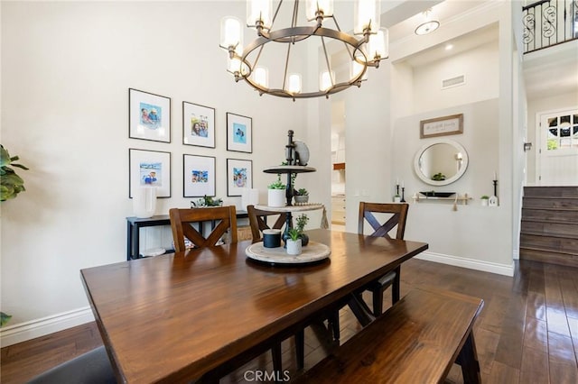 2666 Peacock Pl, La Verne, CA 91750 - dining area featuring a chandelier, dark wood-style flooring, a towering ceiling, and stairs