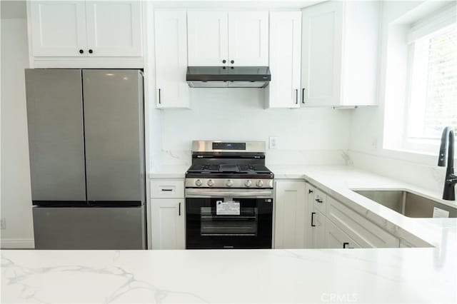 41 Scottsdale S, Carson, CA 90745 - kitchen featuring stainless steel appliances, under cabinet range hood, white cabinetry, and light stone counters