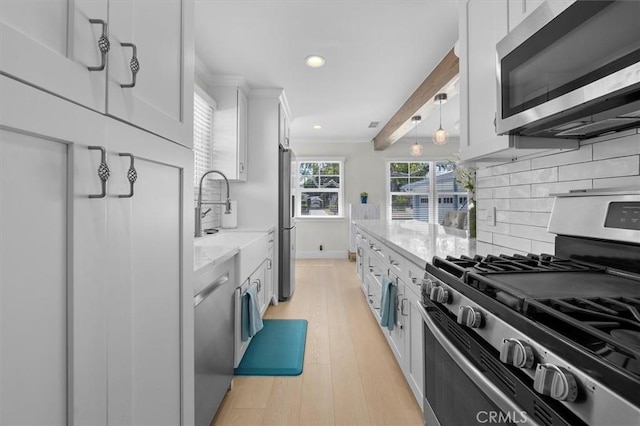 5535 W 142nd Pl, Hawthorne, CA 90250 - kitchen featuring appliances with stainless steel finishes, white cabinetry, recessed lighting, backsplash, and light wood-style floors