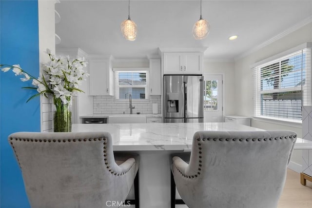 5535 W 142nd Pl, Hawthorne, CA 90250 - kitchen featuring stainless steel fridge with ice dispenser, a breakfast bar, white cabinets, decorative backsplash, and light stone countertops