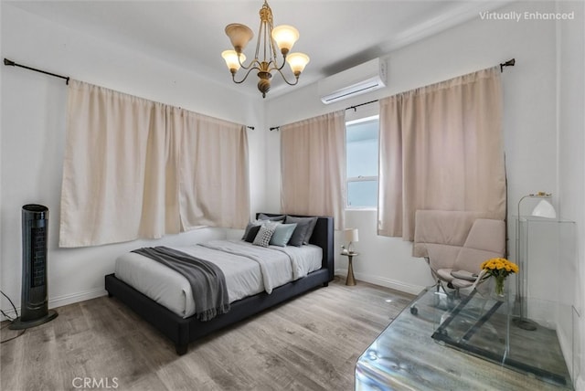 2925 Lemon St, Riverside, CA 92501 - bedroom featuring a wall mounted air conditioner, wood finished floors, and a chandelier