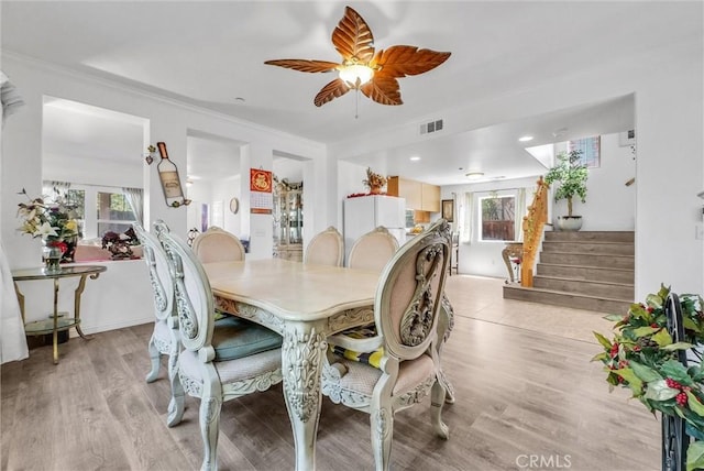 2925 Lemon St, Riverside, CA 92501 - dining space with stairs, light wood-style flooring, ceiling fan, and ornamental molding