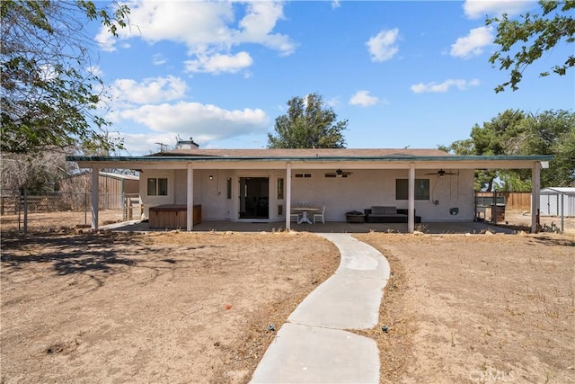8558 W W Ave E8, Lancaster, CA 93536 - back of property featuring a hot tub, ceiling fan, a patio, and stucco siding