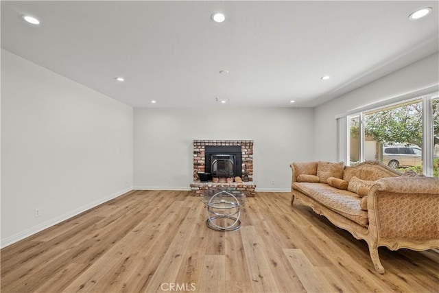 8558 W W Ave E8, Lancaster, CA 93536 - living room with light wood-style floors, recessed lighting, and a brick fireplace