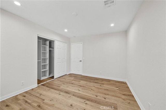8558 W W Ave E8, Lancaster, CA 93536 - unfurnished bedroom featuring wood finished floors, recessed lighting, and a closet