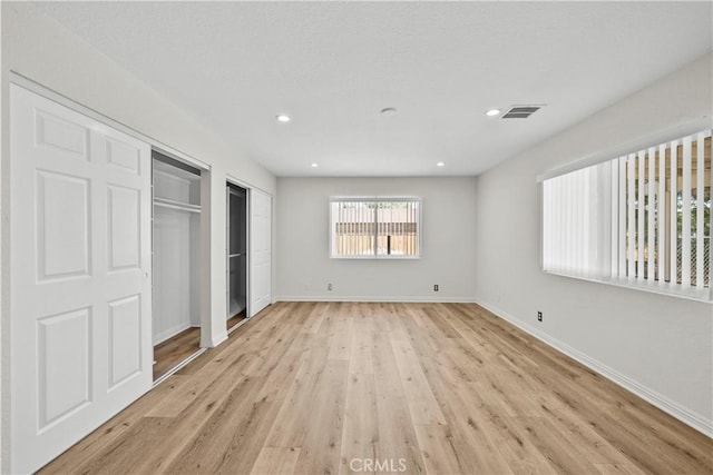 8558 W W Ave E8, Lancaster, CA 93536 - unfurnished bedroom with light wood-type flooring and recessed lighting