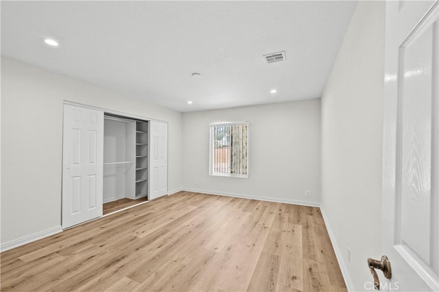 8558 W W Ave E8, Lancaster, CA 93536 - unfurnished bedroom featuring light wood-style flooring, recessed lighting, and a closet