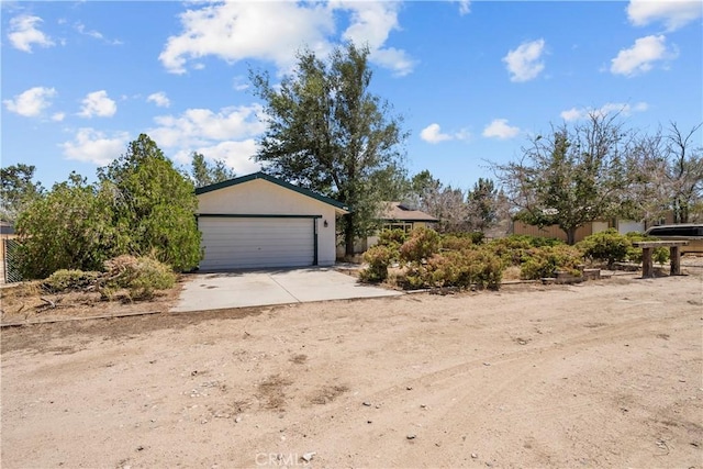 8558 W W Ave E8, Lancaster, CA 93536 - view of front facade featuring an attached garage and concrete driveway