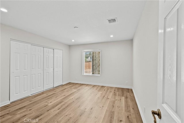 8558 W W Ave E8, Lancaster, CA 93536 - unfurnished bedroom featuring light wood finished floors, recessed lighting, and a closet