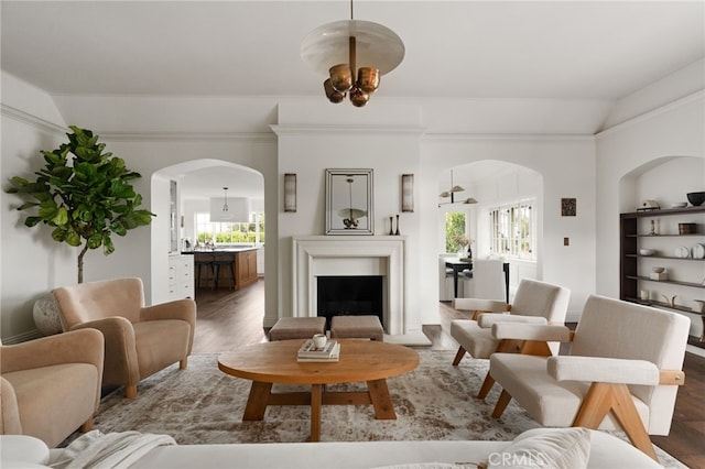 4730 Angeles Vista Blvd, View Park, CA 90043 - living area with arched walkways, vaulted ceiling, plenty of natural light, wood finished floors, and a fireplace