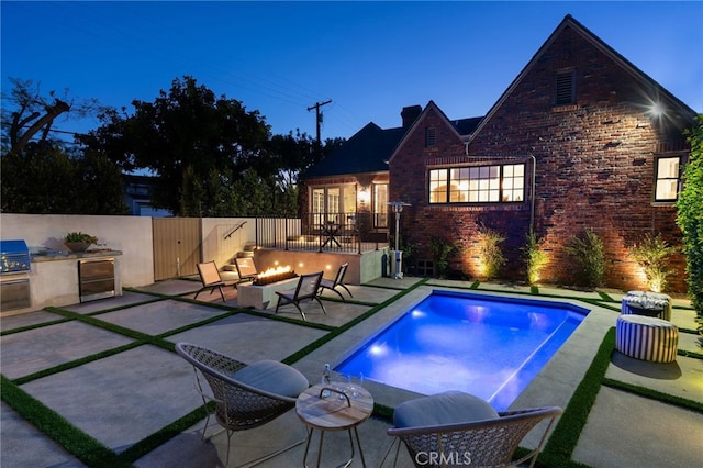 4730 Angeles Vista Blvd, View Park, CA 90043 - back of property with area for grilling, an outdoor fire pit, a patio, a fenced backyard, and brick siding