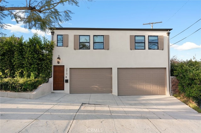 4730 Angeles Vista Blvd, View Park, CA 90043 - view of front of house featuring a garage, driveway, and stucco siding