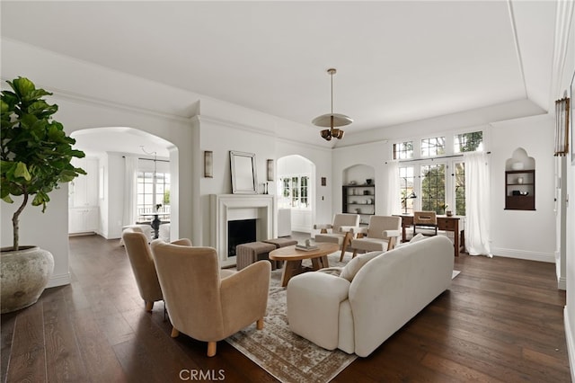 4730 Angeles Vista Blvd, View Park, CA 90043 - living area featuring arched walkways, dark wood finished floors, and built in shelves