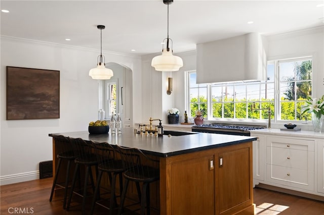 4730 Angeles Vista Blvd, View Park, CA 90043 - kitchen with healthy amount of natural light, crown molding, dark wood finished floors, white cabinetry, and recessed lighting
