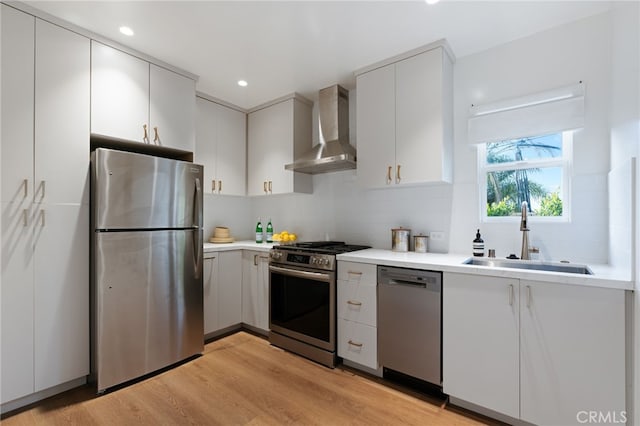 4730 Angeles Vista Blvd, View Park, CA 90043 - kitchen with stainless steel appliances, wall chimney range hood, light wood-style floors, light countertops, and recessed lighting