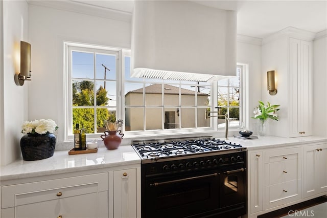 4730 Angeles Vista Blvd, View Park, CA 90043 - kitchen with double oven range, crown molding, plenty of natural light, and white cabinets