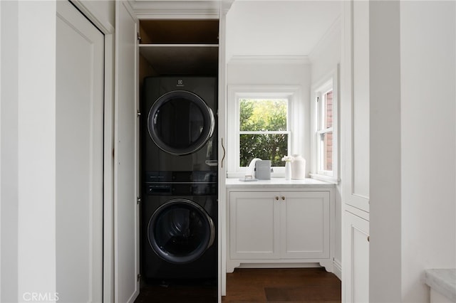4730 Angeles Vista Blvd, View Park, CA 90043 - laundry area featuring stacked washer and clothes dryer, dark wood-style floors, and crown molding