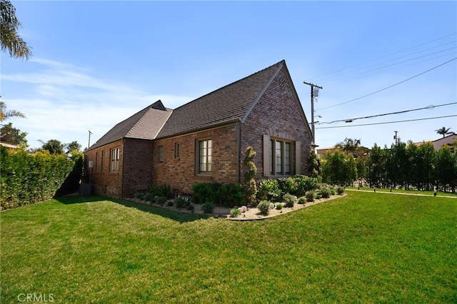4730 Angeles Vista Blvd, View Park, CA 90043 - view of side of home with brick siding, a yard, and a shingled roof
