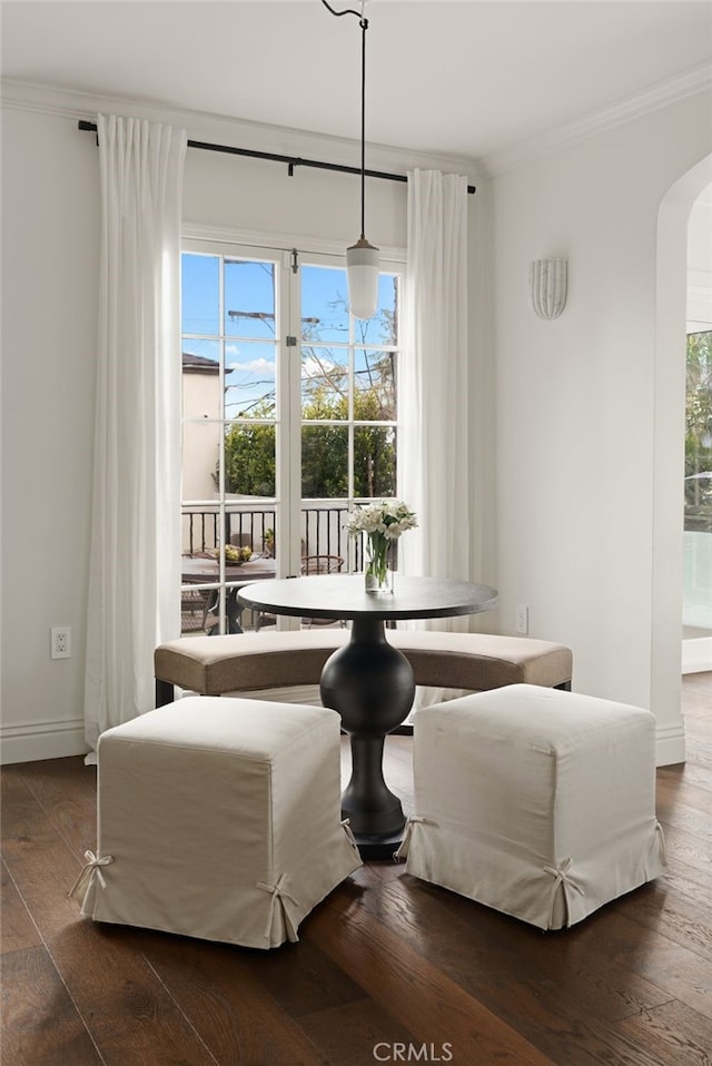 4730 Angeles Vista Blvd, View Park, CA 90043 - dining space featuring ornamental molding, arched walkways, and dark wood-style flooring