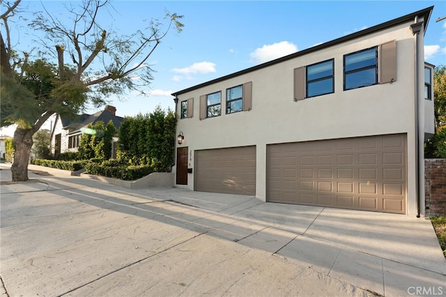 4730 Angeles Vista Blvd, View Park, CA 90043 - view of front facade featuring an attached garage, concrete driveway, and stucco siding