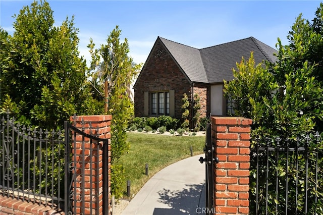 4730 Angeles Vista Blvd, View Park, CA 90043 - view of front facade with a gate, brick siding, and a shingled roof