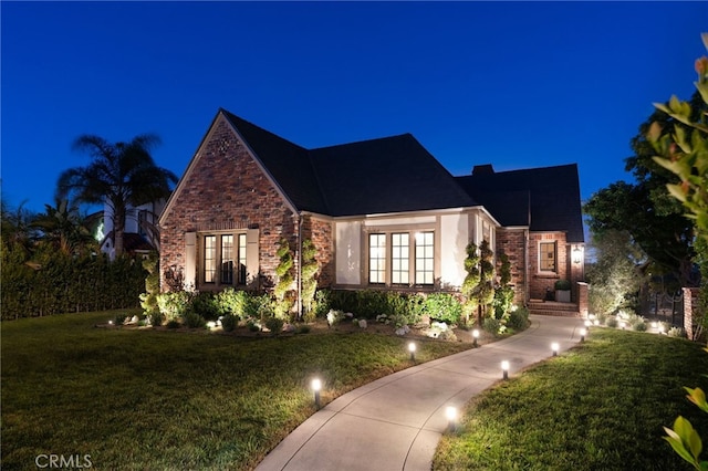 4730 Angeles Vista Blvd, View Park, CA 90043 - english style home featuring a yard, french doors, and brick siding