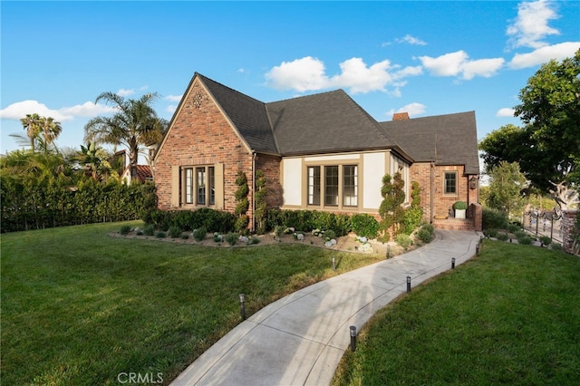 4730 Angeles Vista Blvd, View Park, CA 90043 - english style home with a front lawn, brick siding, a chimney, and a shingled roof