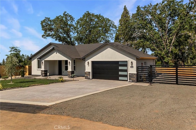 5909 Del Mar Ave, Paradise, CA 95969 - view of front of home featuring a garage, stucco siding, stone siding, driveway, and a gate