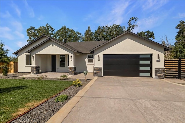 5909 Del Mar Ave, Paradise, CA 95969 - view of front of home with stone siding, stucco siding, a garage, and concrete driveway