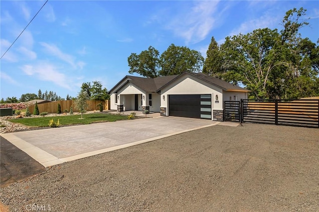 5909 Del Mar Ave, Paradise, CA 95969 - ranch-style house featuring an attached garage, stucco siding, concrete driveway, stone siding, and a gate