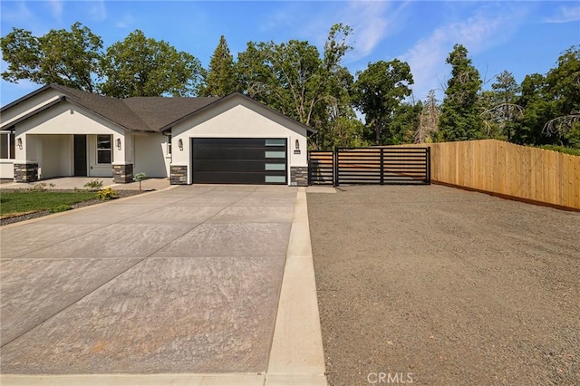 5909 Del Mar Ave, Paradise, CA 95969 - view of front of property featuring an attached garage, concrete driveway, stucco siding, stone siding, and a gate