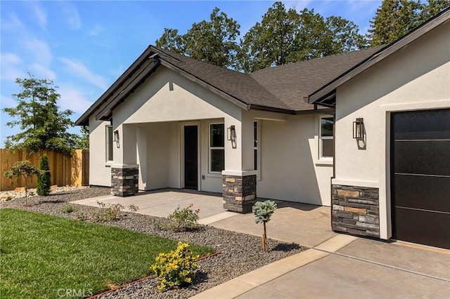 5909 Del Mar Ave, Paradise, CA 95969 - view of exterior entry featuring stucco siding, stone siding, and roof with shingles
