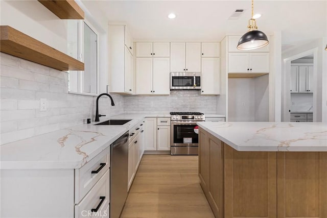 5909 Del Mar Ave, Paradise, CA 95969 - kitchen with appliances with stainless steel finishes, tasteful backsplash, light stone counters, light wood-style flooring, and recessed lighting