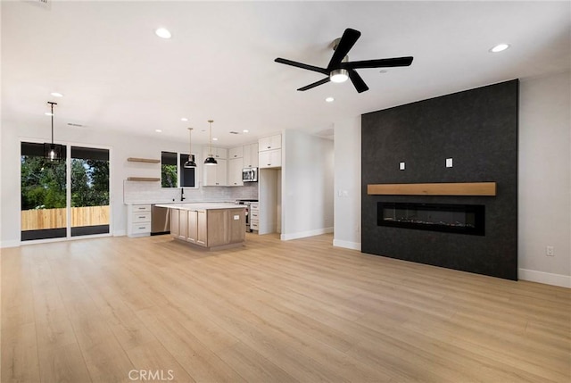 5909 Del Mar Ave, Paradise, CA 95969 - unfurnished living room with ceiling fan, light wood-style floors, recessed lighting, and a large fireplace
