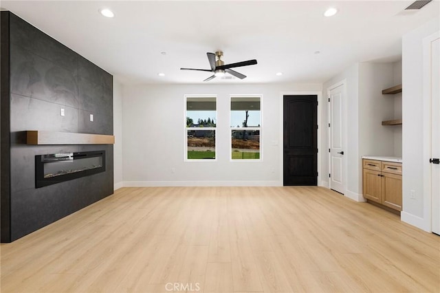 5909 Del Mar Ave, Paradise, CA 95969 - unfurnished living room featuring a large fireplace, recessed lighting, a ceiling fan, and light wood finished floors