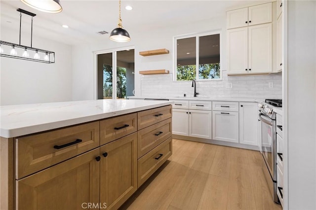 5909 Del Mar Ave, Paradise, CA 95969 - kitchen featuring stainless steel range with electric cooktop, tasteful backsplash, light wood-style flooring, white cabinets, and recessed lighting