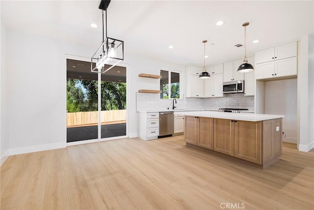 5909 Del Mar Ave, Paradise, CA 95969 - kitchen featuring stainless steel appliances, open shelves, tasteful backsplash, light countertops, and light wood-type flooring