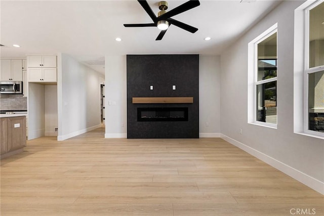 5909 Del Mar Ave, Paradise, CA 95969 - unfurnished living room with light wood-type flooring, recessed lighting, a large fireplace, and ceiling fan