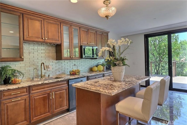 182 Denslow Ave, Los Angeles, CA 90049 - kitchen with appliances with stainless steel finishes, tasteful backsplash, light stone counters, a breakfast bar, and brown cabinets