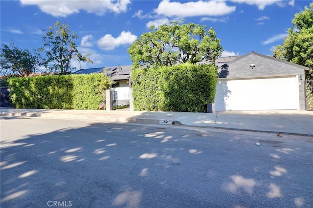 182 Denslow Ave, Los Angeles, CA 90049 - obstructed view of property featuring concrete driveway
