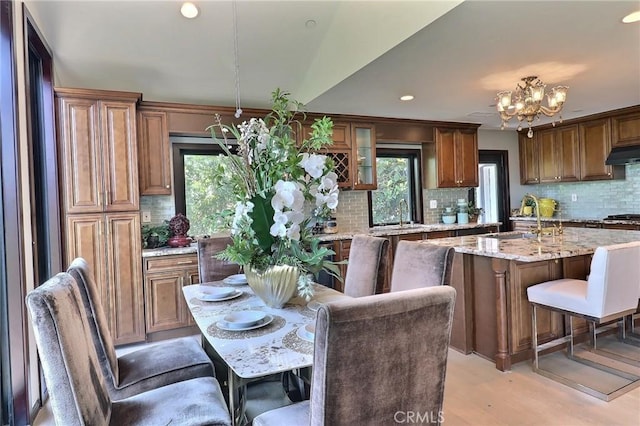 182 Denslow Ave, Los Angeles, CA 90049 - kitchen featuring under cabinet range hood, a chandelier, decorative backsplash, plenty of natural light, and recessed lighting