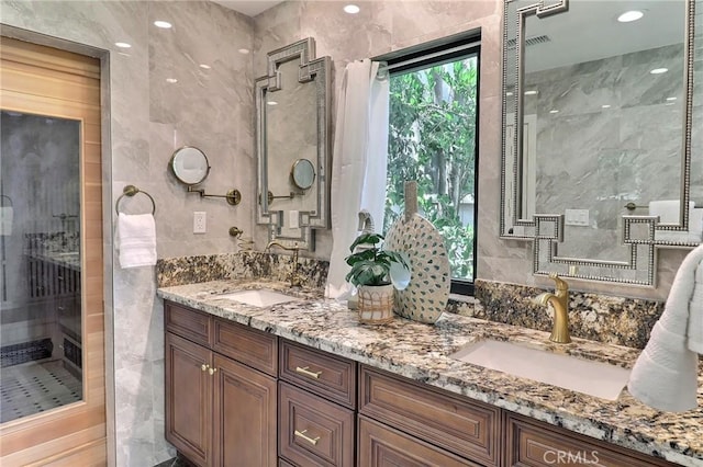 182 Denslow Ave, Los Angeles, CA 90049 - full bathroom with tile walls, double vanity, a walk in shower, and recessed lighting