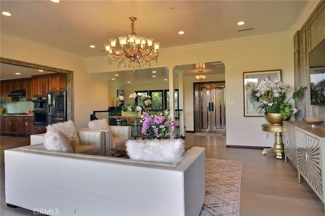182 Denslow Ave, Los Angeles, CA 90049 - living room featuring a chandelier, wood finished floors, crown molding, and recessed lighting