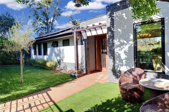 182 Denslow Ave, Los Angeles, CA 90049 - doorway to property with a lawn and brick siding
