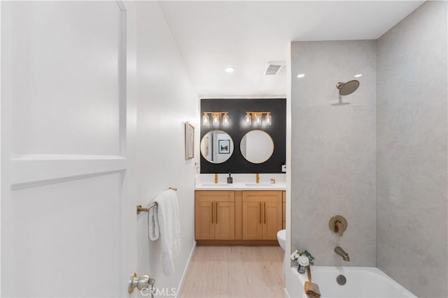 611 Griffith St, San Fernando, CA 91340 - bathroom featuring double vanity, bathing tub / shower combination, wood finished floors, and recessed lighting