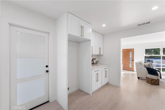 611 Griffith St, San Fernando, CA 91340 - kitchen with light wood finished floors, white cabinetry, light countertops, recessed lighting, and open floor plan