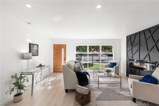 611 Griffith St, San Fernando, CA 91340 - living room featuring light wood-style flooring, a large fireplace, and recessed lighting