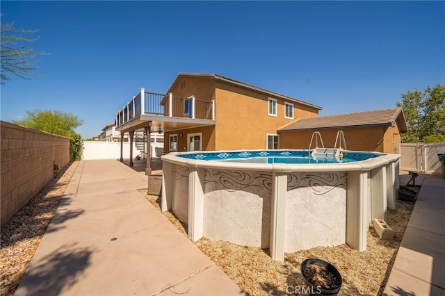 26649 Azalea St, Moreno Valley, CA 92555 - back of house with a fenced backyard, stucco siding, and a balcony