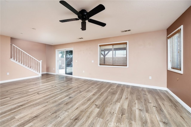 26649 Azalea St, Moreno Valley, CA 92555 - empty room with light wood-style floors, stairway, and a ceiling fan